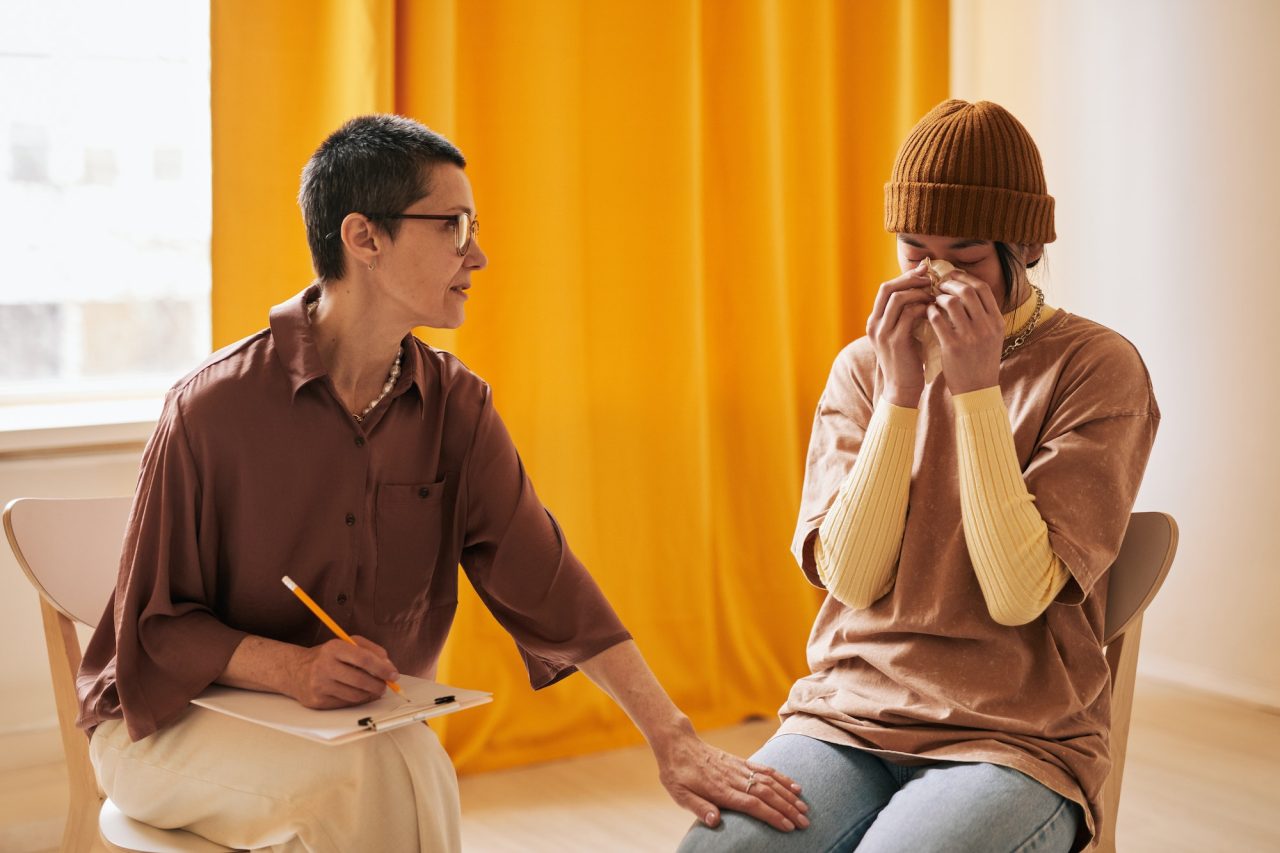 woman crying during addiction treatment therapy