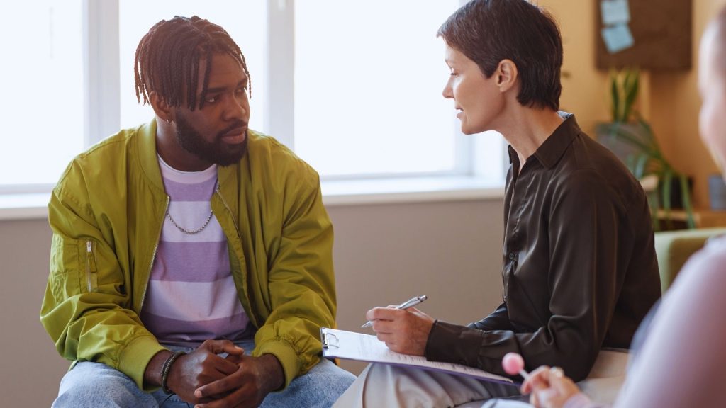 therapist helping a man deal with mental health issues