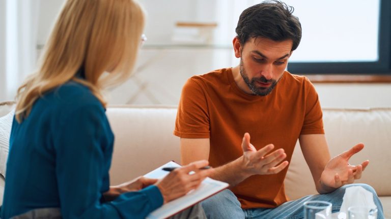 therapist helping a man with opiate addiction during counseling session