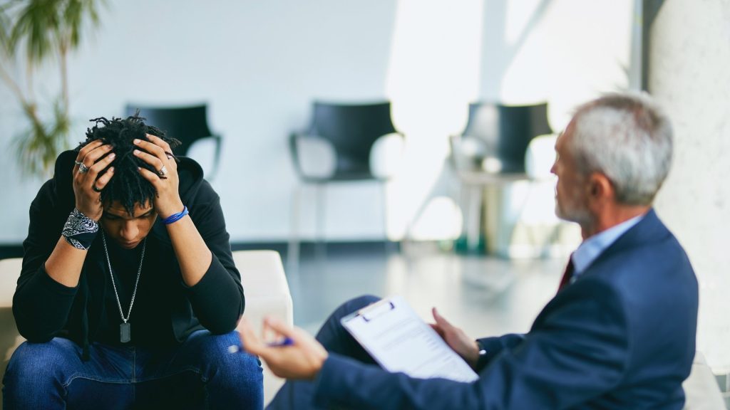 therapist talks to patient about mental health promotion and prevention