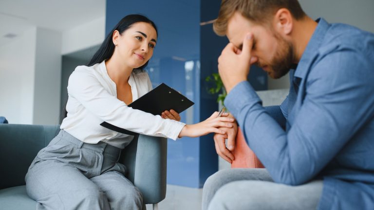 therapist comforts man during therapy for heroin addiction