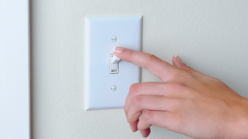 Light switch being flipped, symbolizing changing habits during addiction recovery