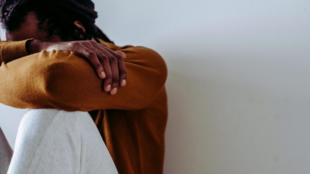 Person sitting alone, overwhelmed as substance use impacts daily life