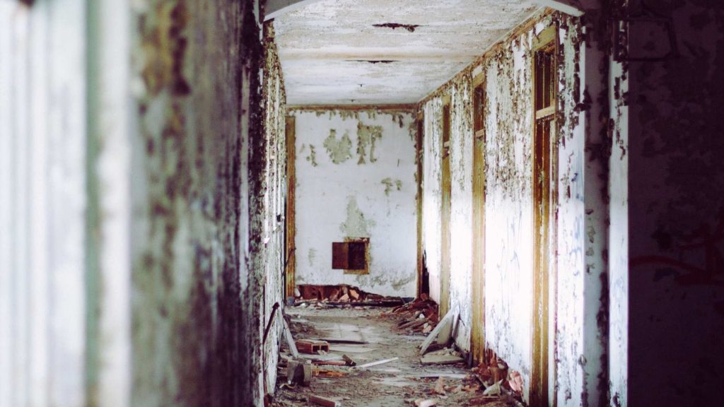 Abandoned hallway symbolizing isolation and loss of stability from addiction