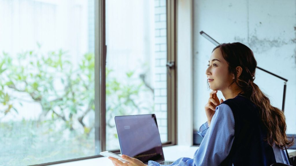 Person working at a laptop while planning time for recovery and treatment