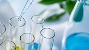 How Long Does OxyContin Stay in Your System hero image of of a drug test being performed in a lab.