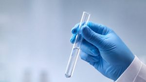 How Long Does Cocaine Stay in Your System hero image of someone holding up a vial during a drug test.