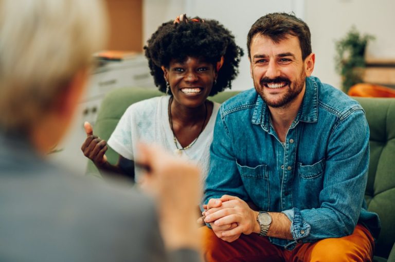 Diverse couple sitting down for a group therapy session