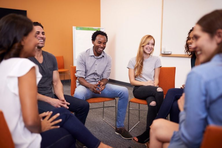 multi cultural group of men and women at mental health group therapy meeting 1