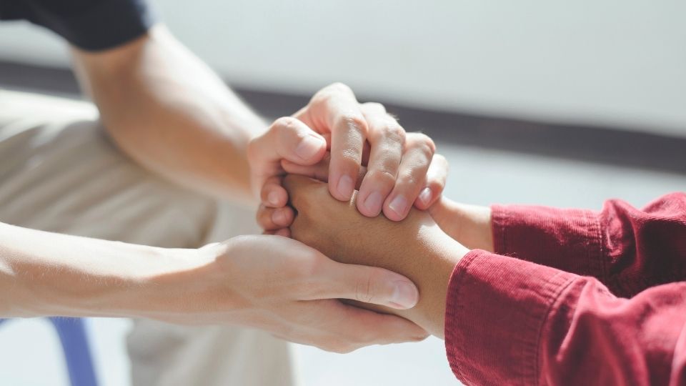 Complex PTSD vs. PTSD hero image of two people in therapy.