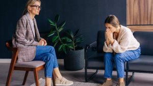 Signs of Unresolved Trauma hero image of a woman in therapy.
